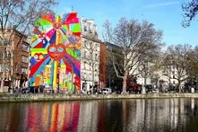 Building of the Paris office of the Heinrich Böll Stiftung. River in front. Behind building with a big colorful graffiti