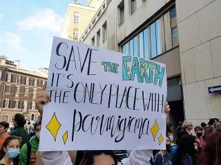 Students marching in Milan for the pre-cop26 at Fridays for Future rally. The sign in the middle says "Save the Earth, is the only place with parmigiana". Picture taken on the 1st of October in 2021. 2021-10-01